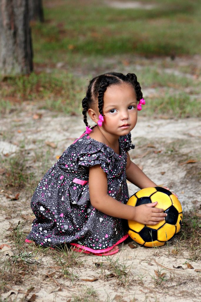 Little girl holding a football